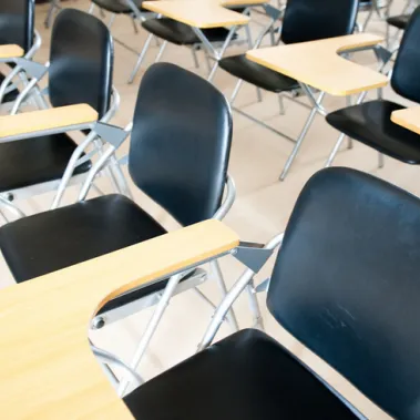 Room full of empty chairs and desks for students