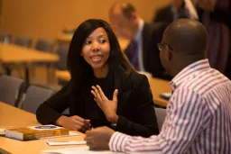 Man and women in conversation at a table