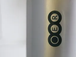 Silver bottle with 'OER' typed on it