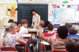 Teacher facing class and answering students' questions