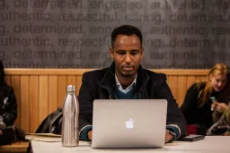 Man sitting at a desk, using laptop